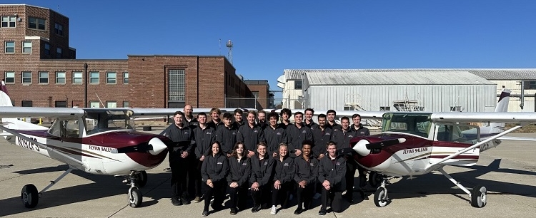 group photo Flying Salukis Flight Team in front of a plane