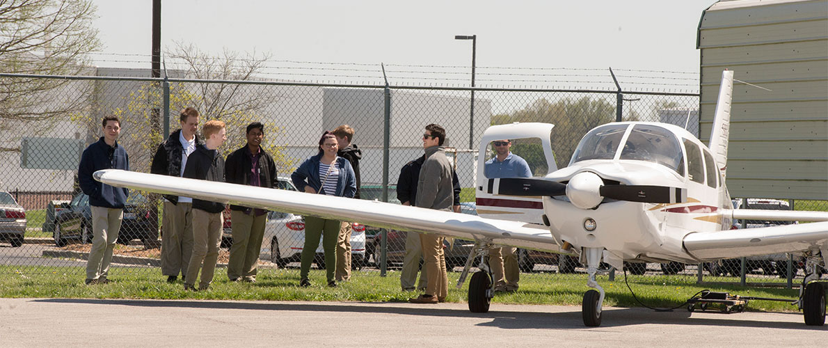 SIU Aviation people standing by airplane